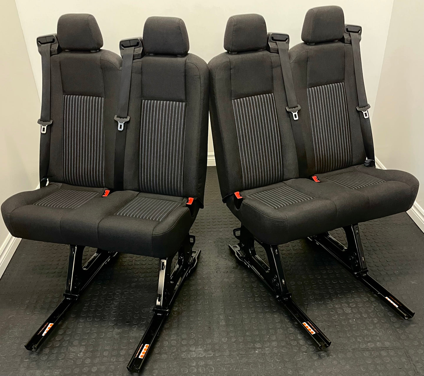 Ford Transit Passenger Van Black Cloth Quick Release Universal Fit 4 Position Bench Seat 64" Wide Including the Seatbelt Retractor.