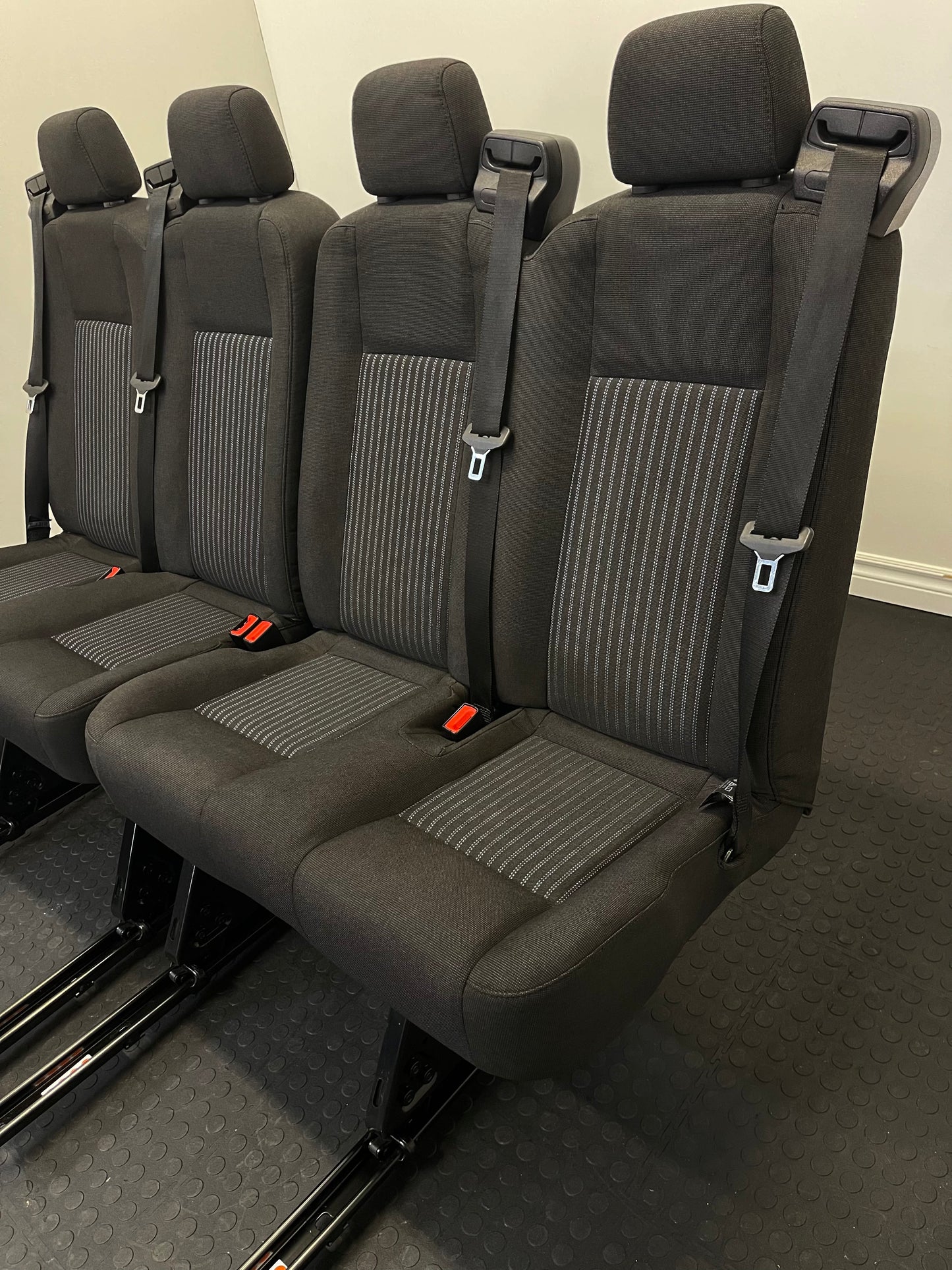 Ford Transit Passenger Van Black Cloth Quick Release Universal Fit 4 Position Bench Seat 64" Wide Including the Seatbelt Retractor.