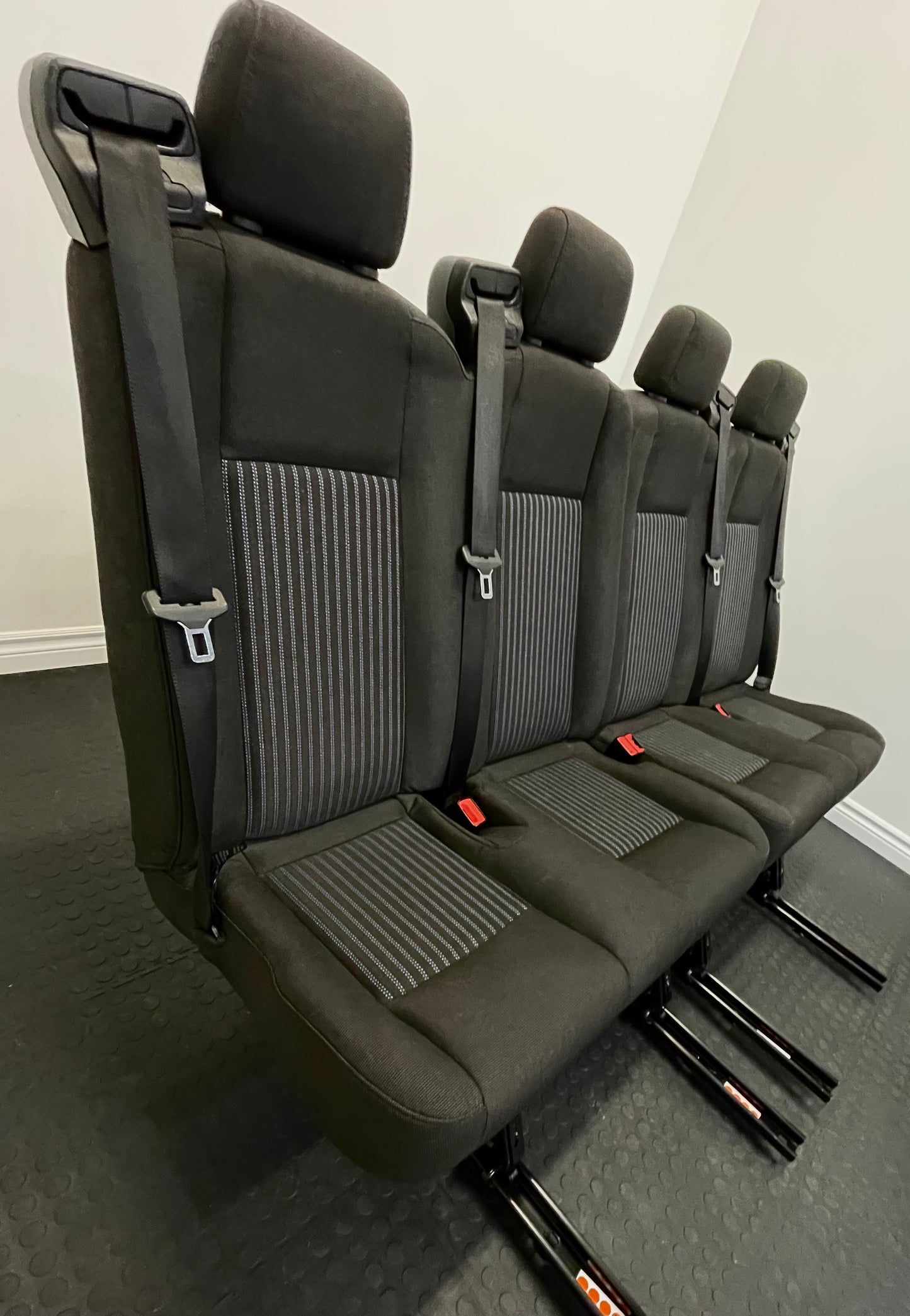 Ford Transit Passenger Van Black Cloth Quick Release Universal Fit 4 Position Bench Seat 64" Wide Including the Seatbelt Retractor.